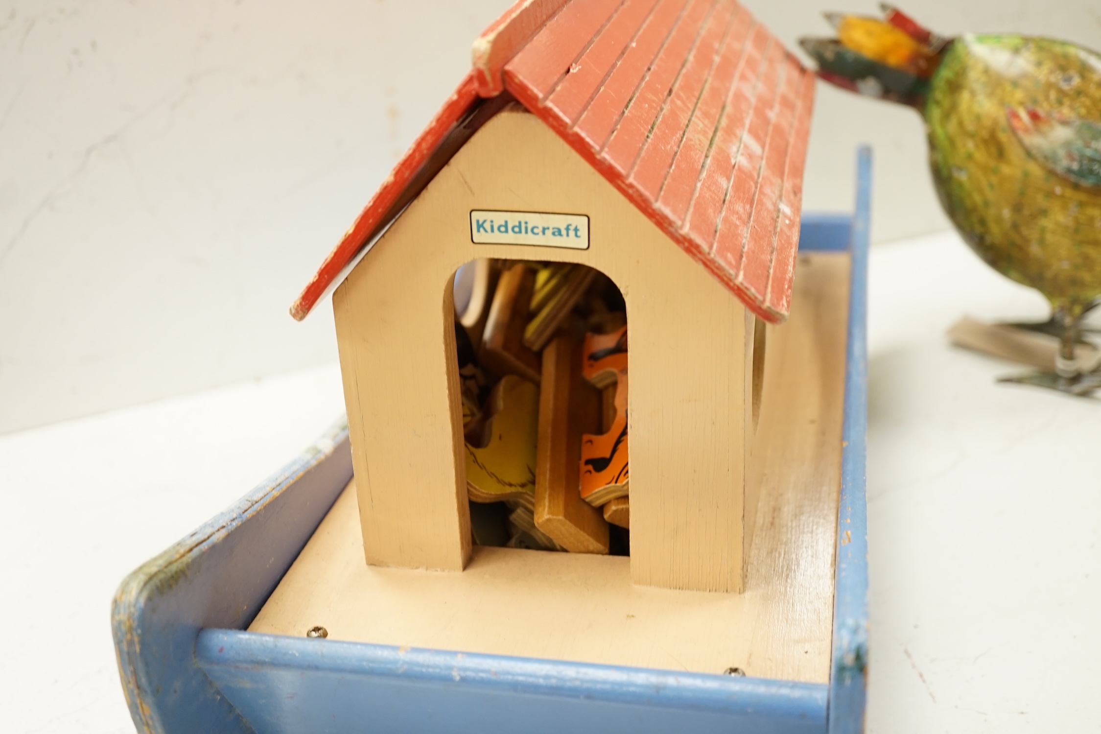 A painted ply Noah's Ark with animals, two Victorian iron door stops, a painted toleware cockerel and an oil on canvas of a harbour view. Condition - varies